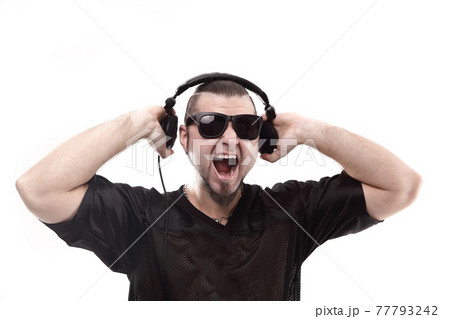 close up. stylish rapper shows headphones .isolated on white 77793242