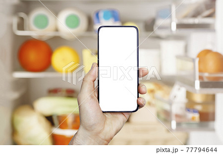Online grocery delivery app in a mobile phone. Food market service in smartphone. Grocery delivery background concept. Shopping cart. Empty blank screen 77794644