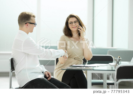 side view.handshake businessman and businesswoman at the office Desk 77795343