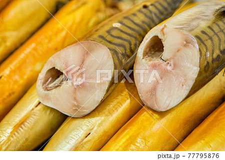 Smoked fish in a cut on a store counter. 77795876