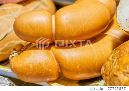 Meat sausages on a store counter. 77795877