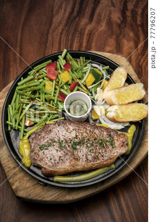 organic tenderloin beef steak sizzler on hot plate meal platter 77796207