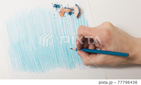 closeup.the artist drawing with a blue pencil on a white sheet closeup.the artist drawing with a blue pencil on a white sheet 77796436