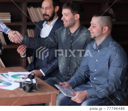 handshake of two designers at a working meeting in the office handshake of two designers at a working meeting in the office 77796486
