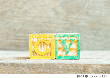 Color alphabet letter block in word CV (Abbreviation of curriculum vitae) on wood background 77797146