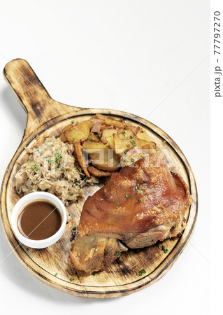 SCHWEINSHAXE traditional german pork knuckle with sauerkraut and potatoes meal 77797270