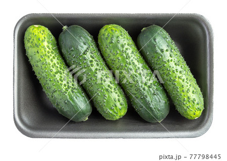 Four cucumbers in the black plastic container isolated on white Four cucumbers in the black plastic container isolated on white 77798445