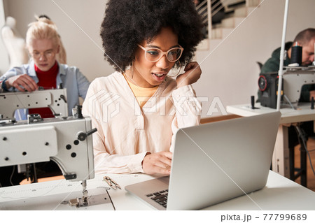 Woman sitting in front of the laptop and chatting with colleagues remotely 77799689