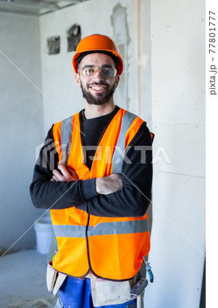 Young handsome worker smiling and looking at the camera 77801777