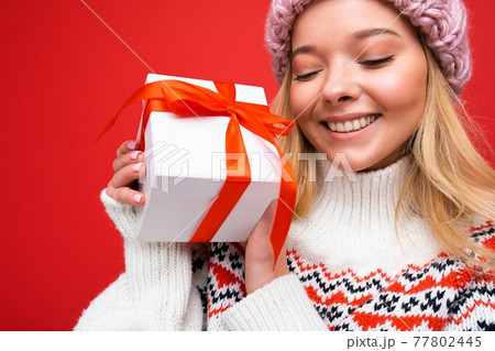 Portrait photo shot of beautiful happy smiling young blonde woman isolated over red background wall Portrait photo shot of beautiful happy smiling young blonde woman isolated over red background wall 77802445