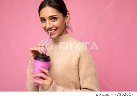 Closeup of Beautiful young positive brunette woman wearing casual stylish clothes isolated over 77802617