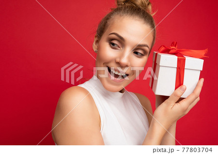 Portrait photo shot of attractive happy amazed young blonde woman isolated over red background wall 77803704