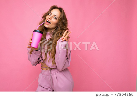 Photo of attractive young happy smiling blonde woman wearing everyday stylish clothes isolated over 77804266