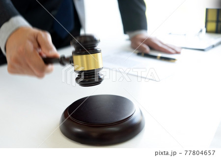 The judge was wave hammering his hand gavel move down 77804657