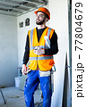 Male worker holding a paper apartment plan indoor before repair room  77804679