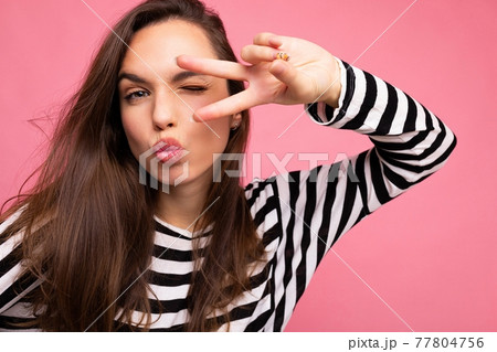 Photo of young positive happy beautiful brunette woman with sincere emotions wearing casual striped 77804756