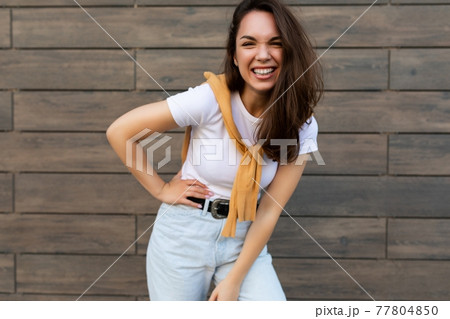 Portrait of successful smiling joyful happy young brunet woman wearing casual white t-shirt and Portrait of successful smiling joyful happy young brunet woman wearing casual white t-shirt and 77804850