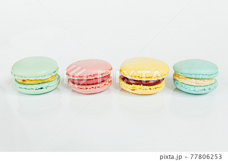 Sweet almond colorful pastel pink blue yellow green macaron or macaroon dessert cake isolated on white background. French sweet cookie. Minimal food bakery concept Copy space Sweet almond colorful pastel pink blue yellow green macaron or macaroon dessert cake isolated on white background. French sweet cookie. Minimal food bakery concept Copy space 77806253