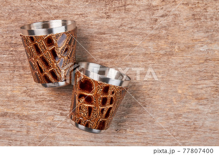 Two hip flask cups close up. 77807400