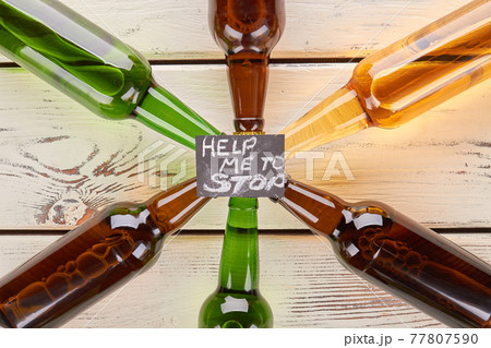 Alcohol dependence concept, wooden table. Alcohol dependence concept, wooden table. 77807590