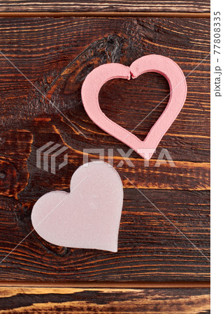 Decorative pink hearts on wooden background. Decorative pink hearts on wooden background. 77808335