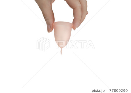 Womans hand holding menstrual cup, period cup isolated on white background with copy space, alternative product zero waste eco friendly 77809290