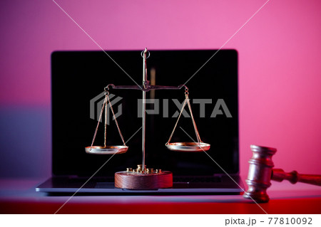 Judge gavel and scales of justice on laptop in notary office 77810092