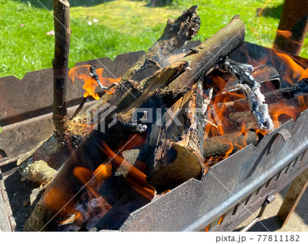 A lit fire for coals in a rusty iron grill for cooking barbecue and fried meat on the fire 77811182