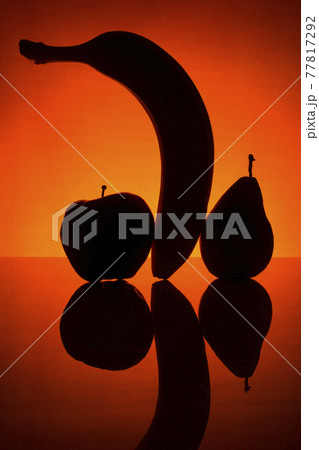 Silhouette of banana, pear and apple on a red background Silhouette of banana, pear and apple on a red background 77817292