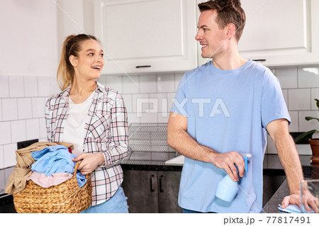 Happy Caucasian Couple Spend Weekends Together Cleaning Home 77817491