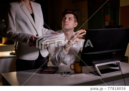 young caucasian man is partial to female colleague, looking at her, in office young caucasian man is partial to female colleague, looking at her, in office 77818056