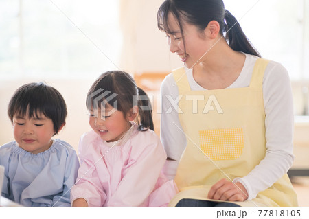 読み聞かせをする保育士 77818105