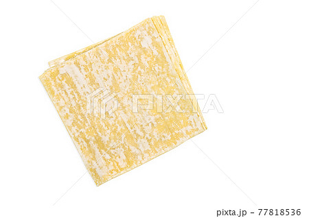Top view stack of Wonton or Chinese dumpling sheets, image with clipping path, isolated yellow dumpling sheets on white background. 77818536