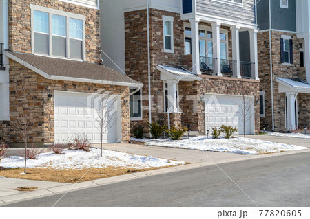 Neighborhood landscape with houses featuring stone brick walls and balcony Neighborhood landscape with houses featuring stone brick walls and balcony 77820605