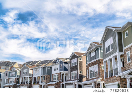 Charming houses in the valley with blue sky and clouds background on a sunny day 77820638