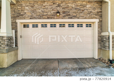 Focus on the wide white panelled wooden door with glass panes of a townhouse 77820914