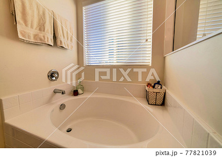 Close up of round built in bathtub inside home bathroom with minimalist design 77821039