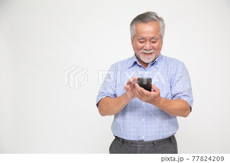 Asian senior man using smartphone and receiving good news from the message on mobile chat application isolated over white background 77824209