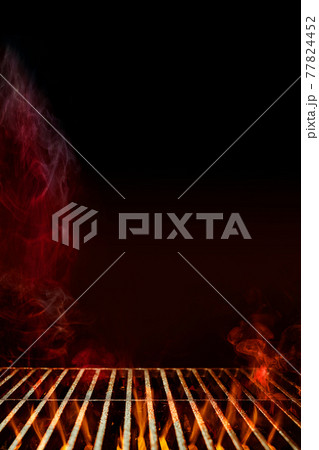 Empty steel barbecue BBQ grill grate with burning fire and smoke against black background. Cooking concept. Close up, copy space Empty steel barbecue BBQ grill grate with burning fire and smoke against black background. Cooking concept. Close up, copy space 77824452