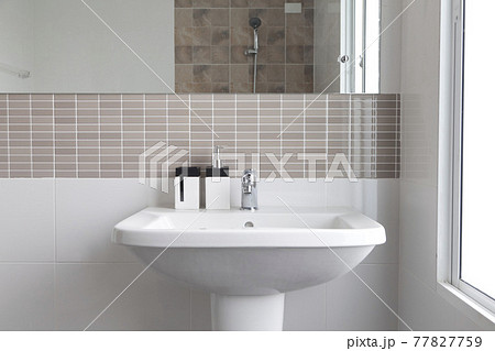 Modern white bathroom sink basin. Interior of bathroom with sink and soap dispenser. Modern design of bathroom. Modern white bathroom sink basin. Interior of bathroom with sink and soap dispenser. Modern design of bathroom. 77827759