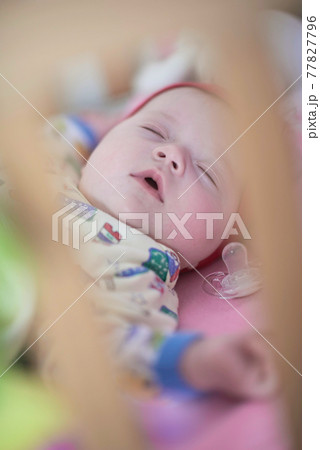 newborn baby sleeping at home in bed 77827796