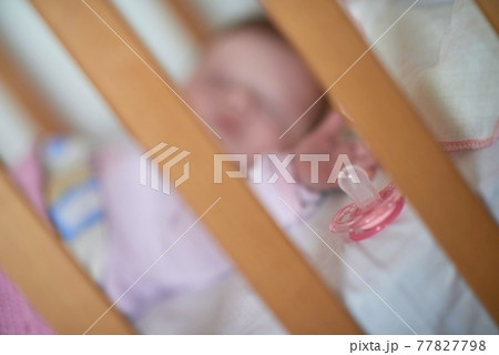 newborn baby sleeping at home in bed 77827798