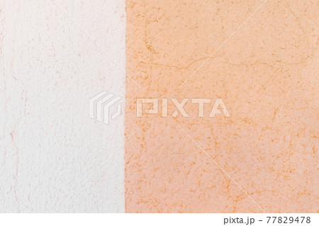 Two colors wall: white plaster and light orange surface with small cracks texture background 77829478