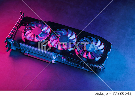 Large and powerful graphics card with three fans with blue pink light. 77830042