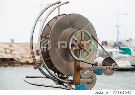 Fishing net winch a on small boat. Close-up Fishing net winch a on small boat. Close-up 77833049