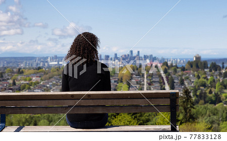 Adult Middle Age Woman sitting outside in a park Adult Middle Age Woman sitting outside in a park 77833128
