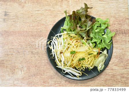 fried yellow vermicelli with cabbage and bean sprout vegetarian food on plate 77833499