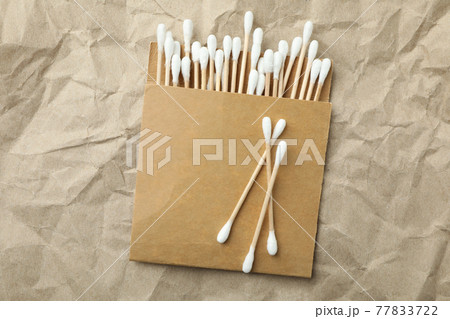Pack of cotton swabs on craft paper background Pack of cotton swabs on craft paper background 77833722