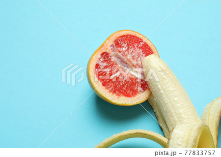 Banana and grapefruit with condensed milk on blue background Banana and grapefruit with condensed milk on blue background 77833757