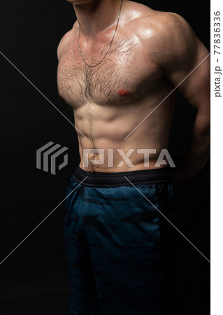 Man on black background keeps dumbbells pumped up in fitness active body muscular workout lifting dumbbell, shirtless weightlifting. Attractive sportive adult, people fit beautiful press with hair 77836336